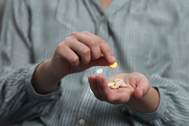 Photo of Closeup view of woman holding antidepressant pills
