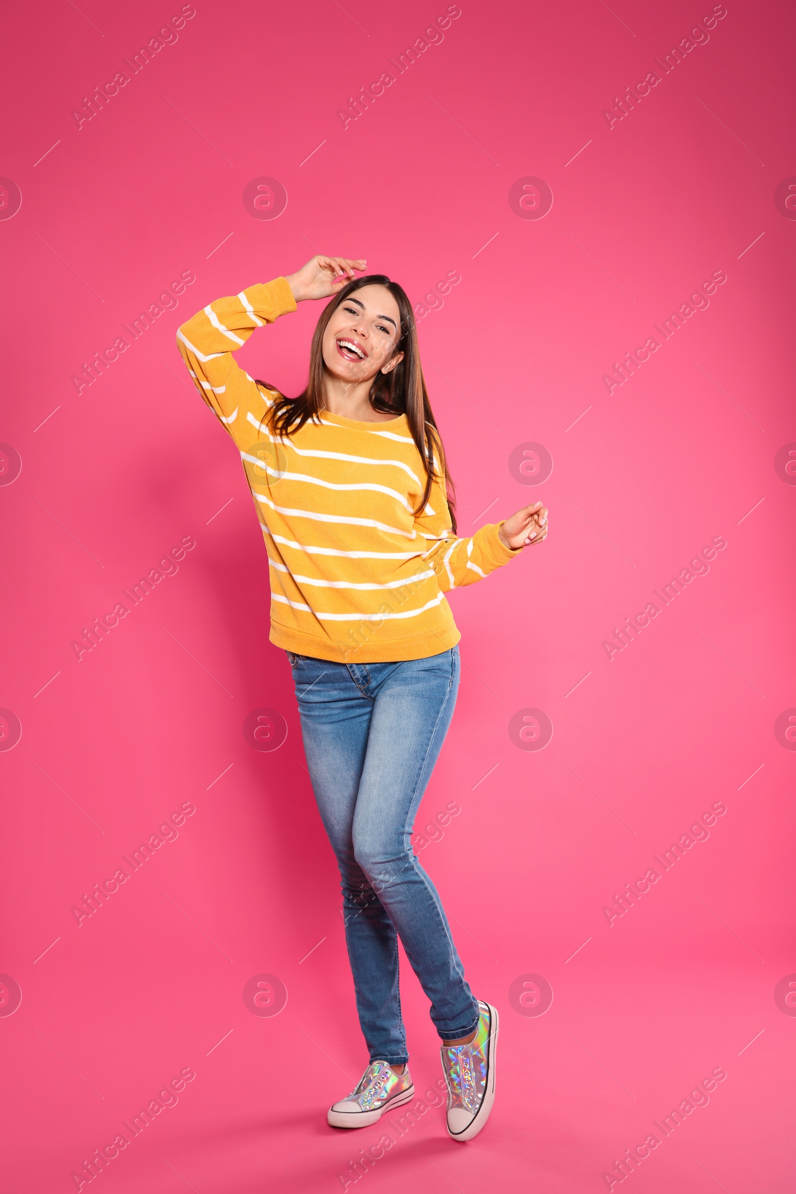 Photo of Full length portrait of emotional woman on color background