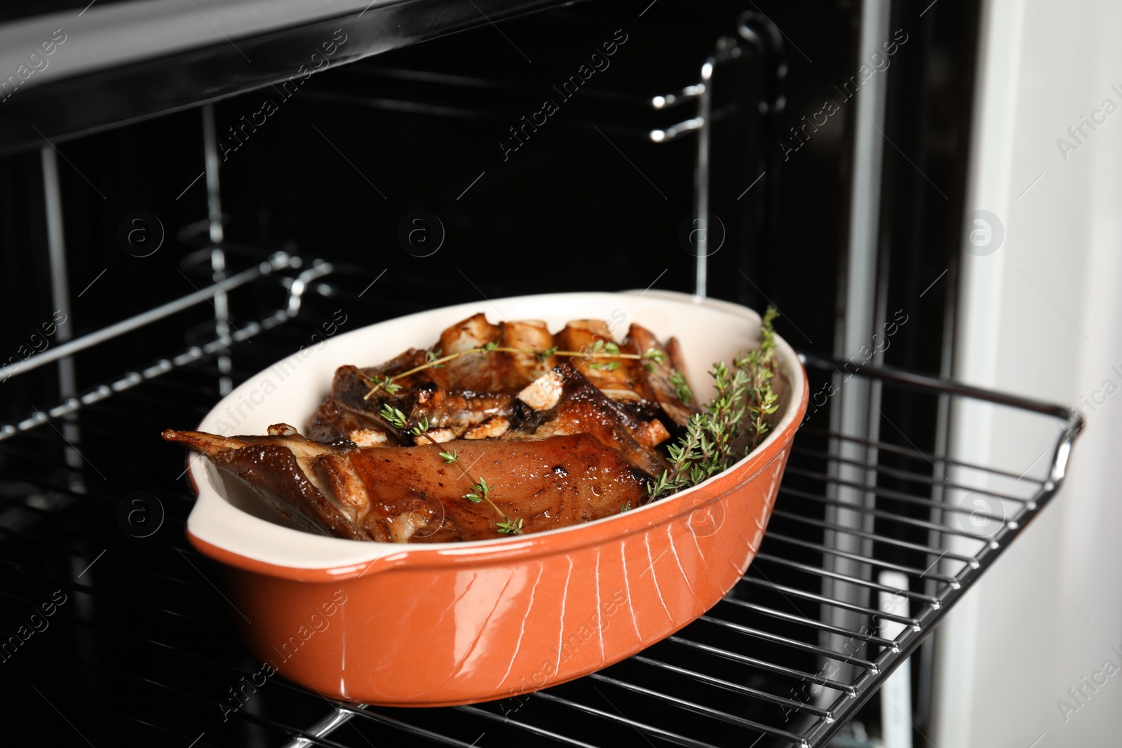 Photo of Delicious roasted ribs with thyme in oven