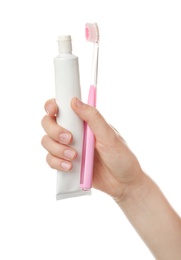 Photo of Woman holding toothbrush and paste against white background. Dental care