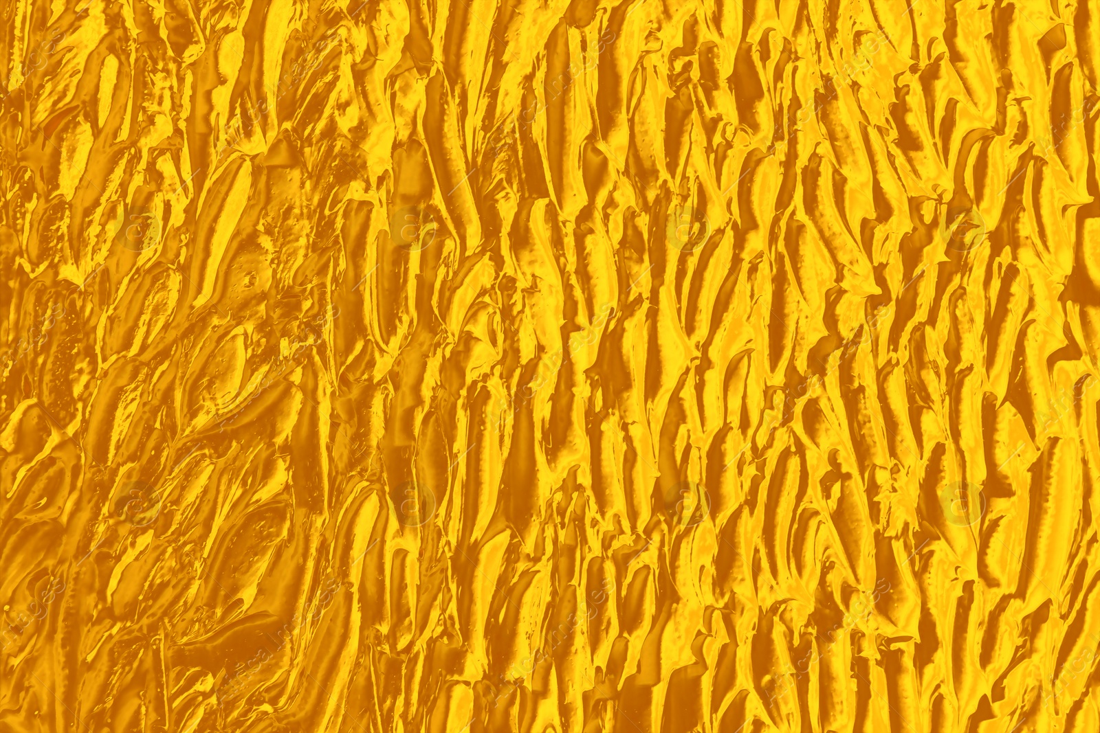 Image of Strokes of golden paint as background, closeup