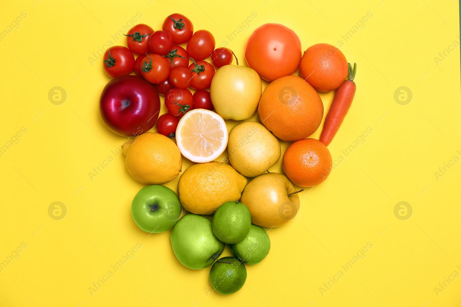 Photo of Rainbow composition with ripe fruits and vegetables on color background, top view