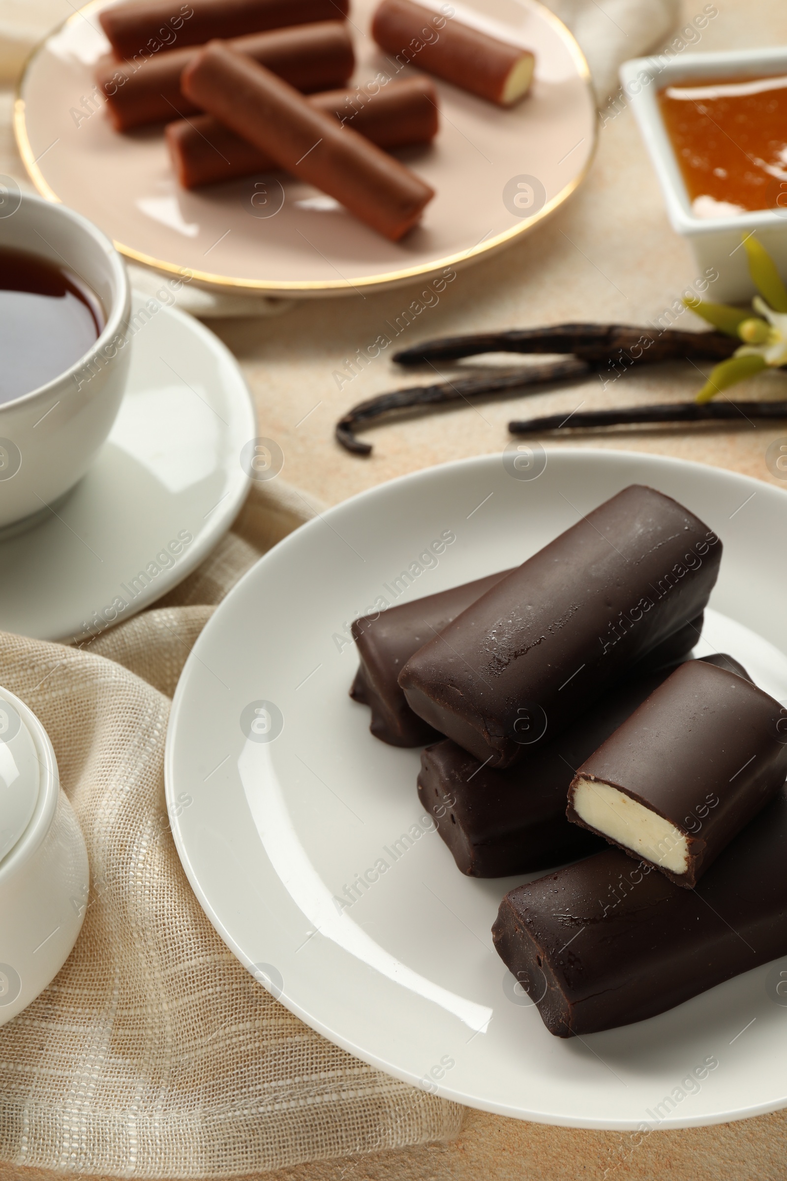 Photo of Glazed vanilla curd cheese bars served on table, closeup