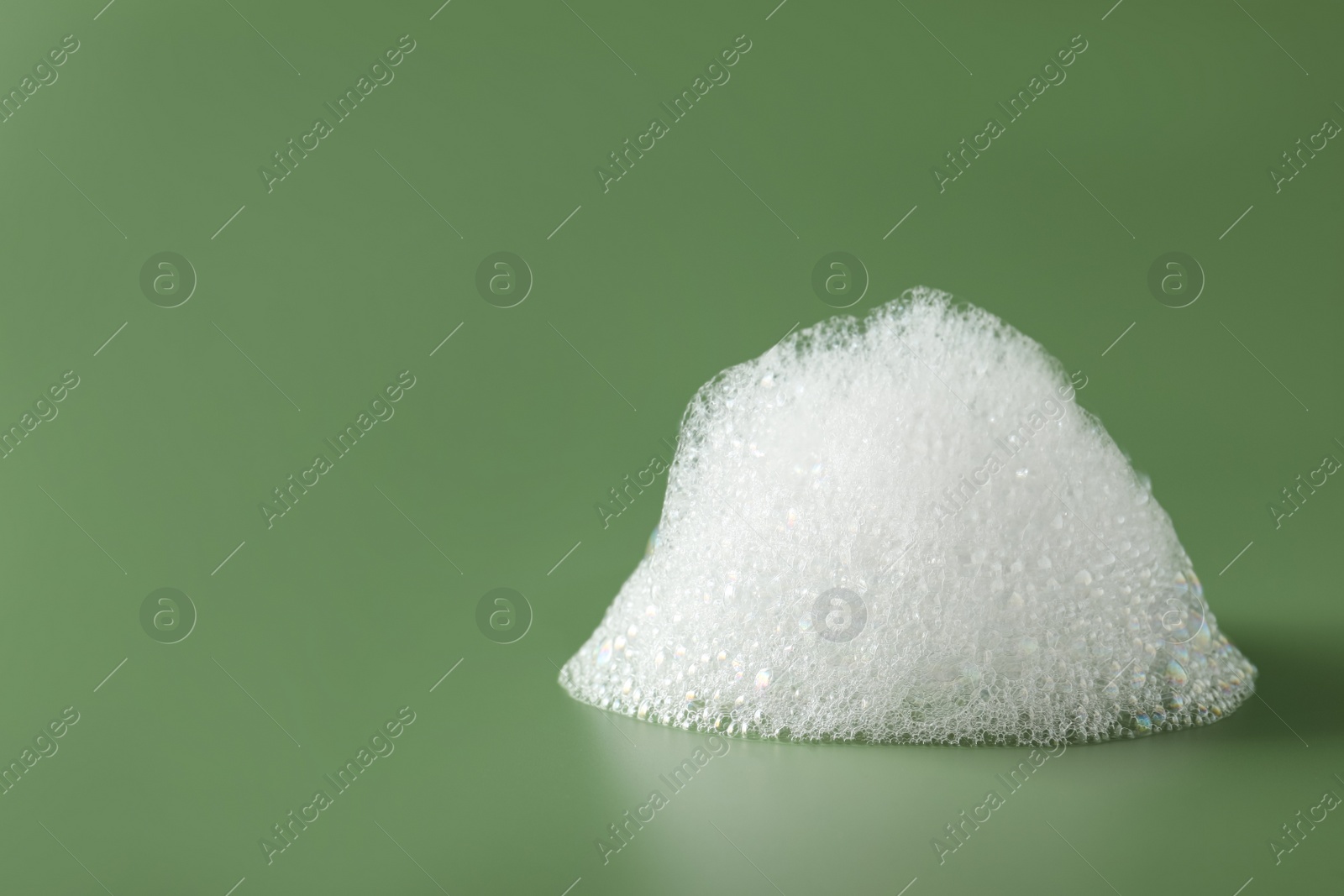 Photo of Drop of fluffy bath foam on olive background. Space for text