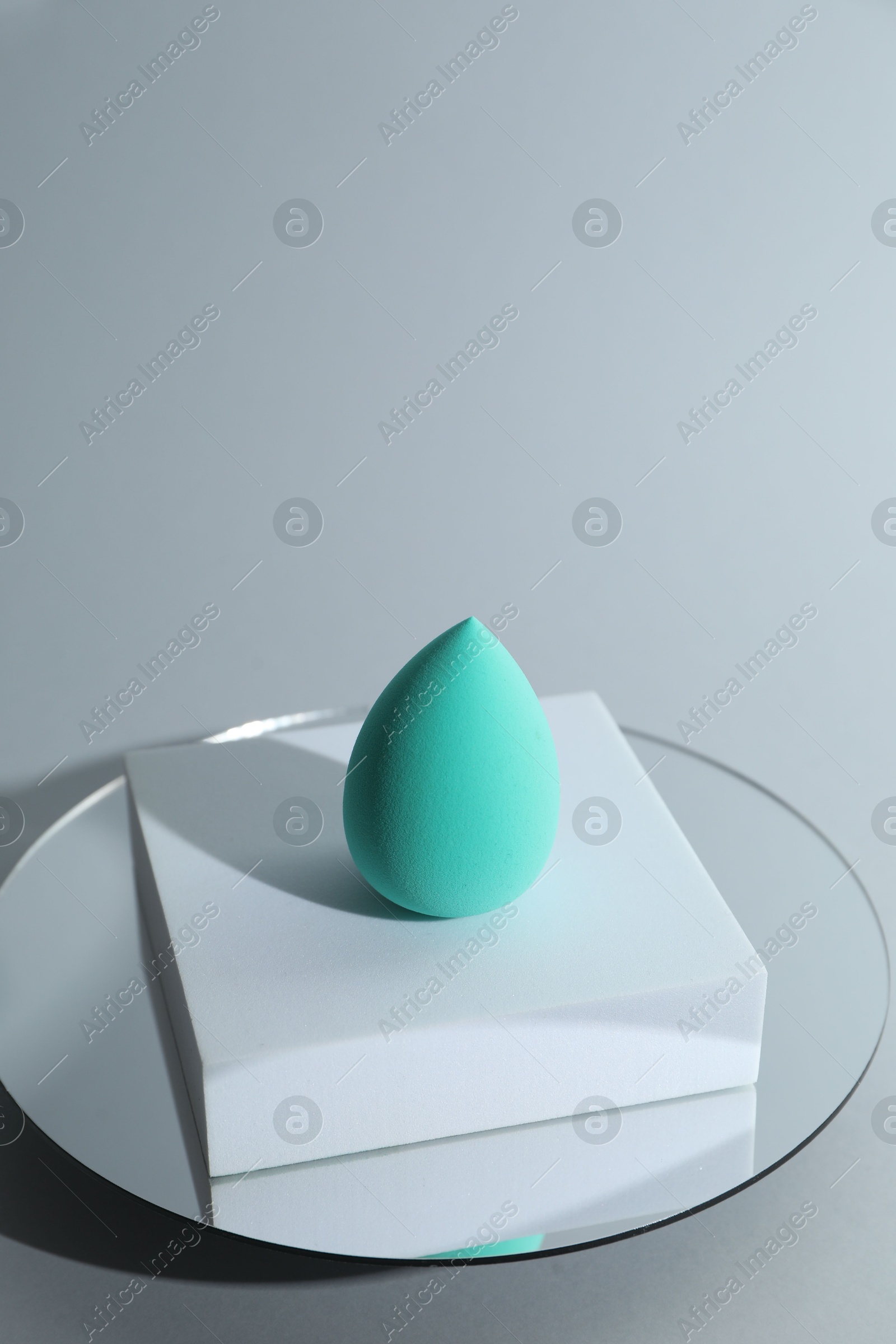 Photo of Stylish presentation of makeup sponge on light grey background