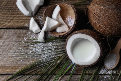 Flat lay composition with coconut milk on wooden table, space for text