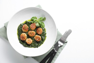 Photo of Delicious fried scallops in bowl served on white table, flat lay. Space for text
