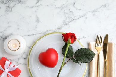 Photo of Place setting with decorative heart on white marble table, flat lay and space for text. Valentine's day romantic dinner