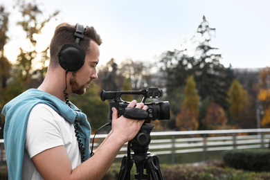 Photo of Video operator with professional camera working outdoors