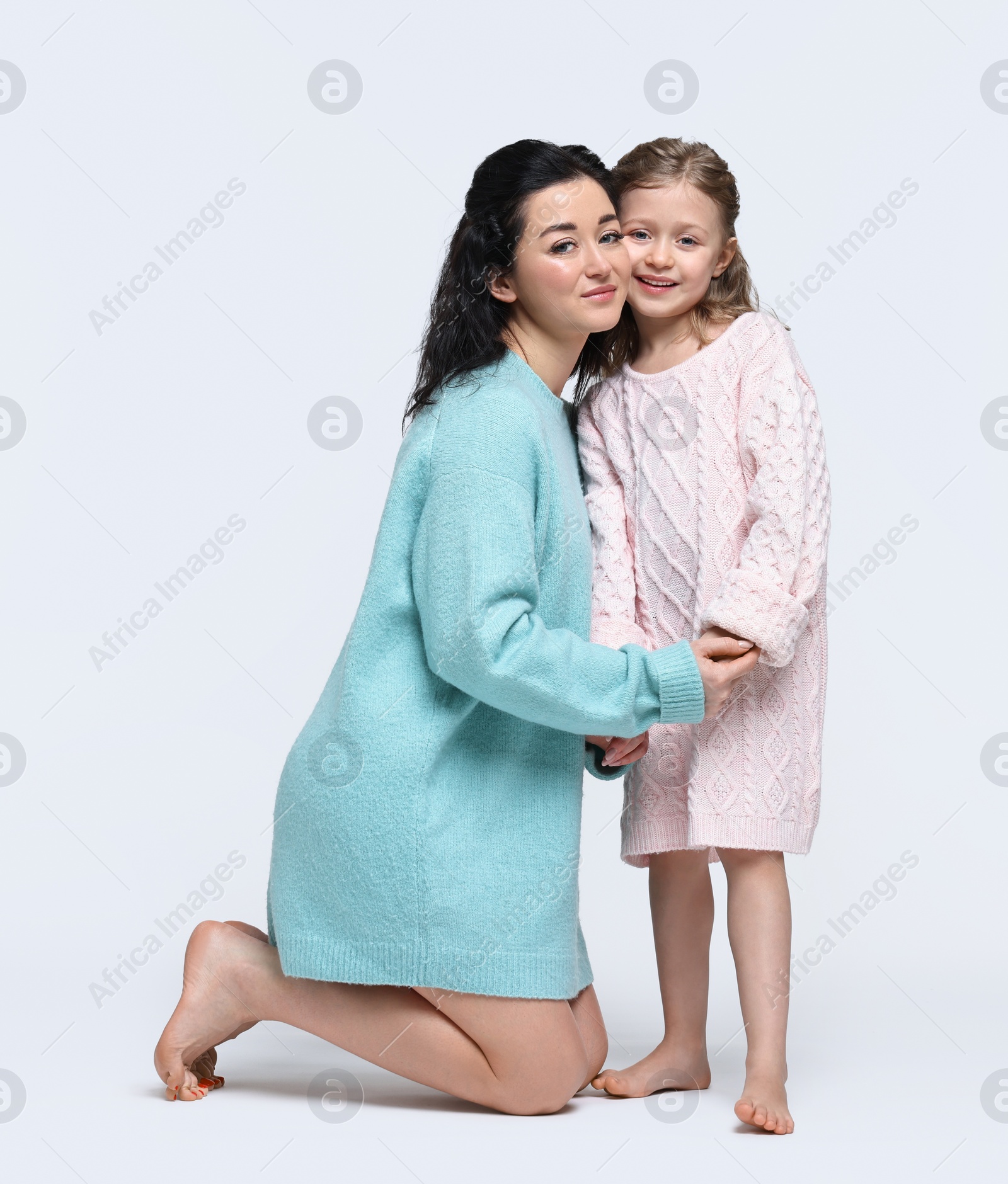 Photo of Beautiful mother with little daughter on white background