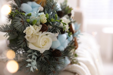 Photo of Beautiful wedding winter bouquet on sofa indoors, closeup. Space for text