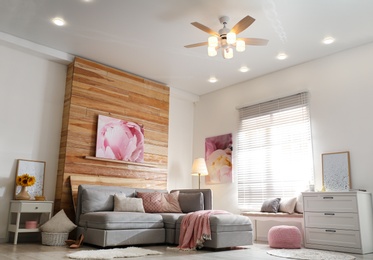 Photo of Stylish living room interior with modern ceiling fan and comfortable couch