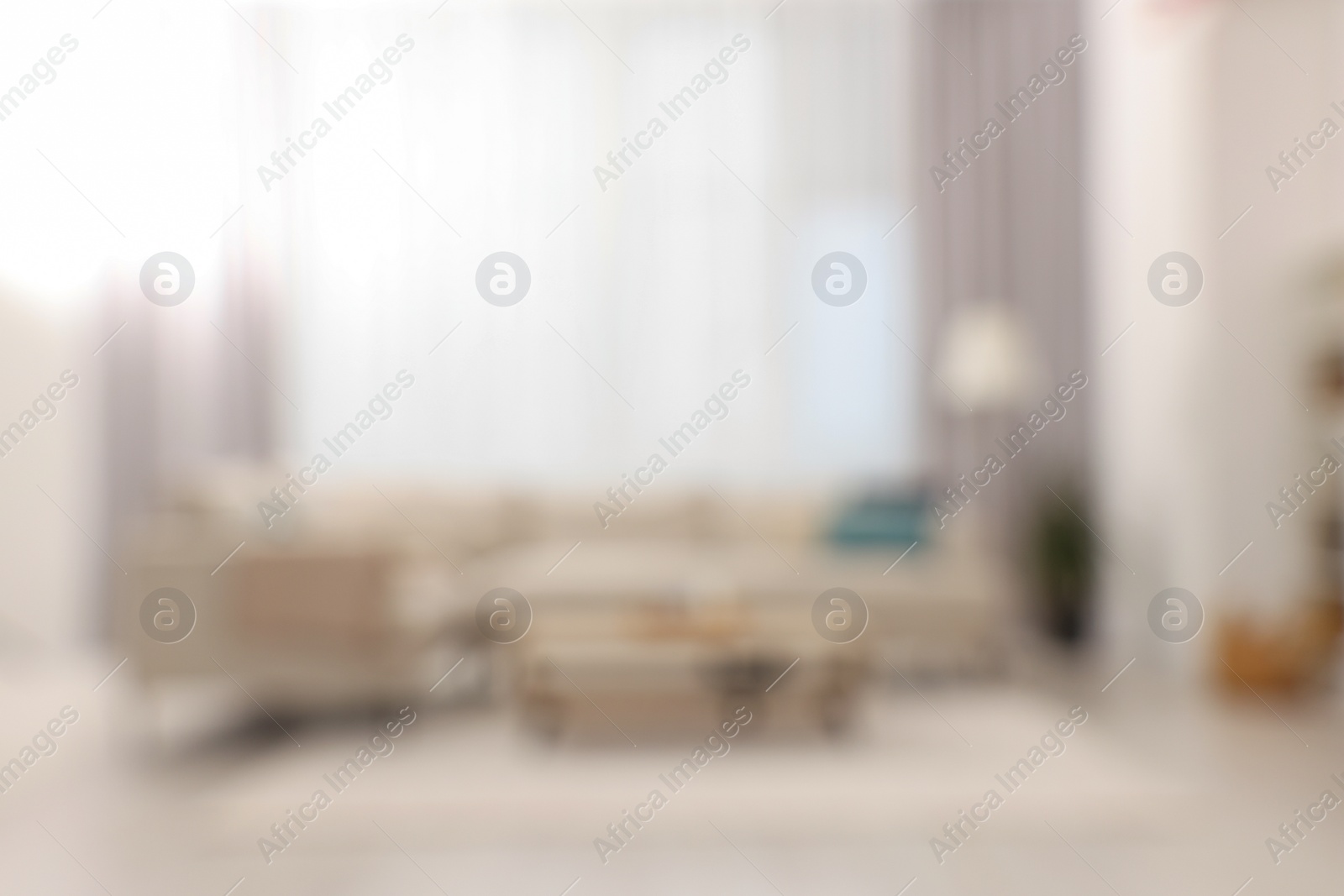 Photo of Blurred view of stylish living room interior with cozy sofa