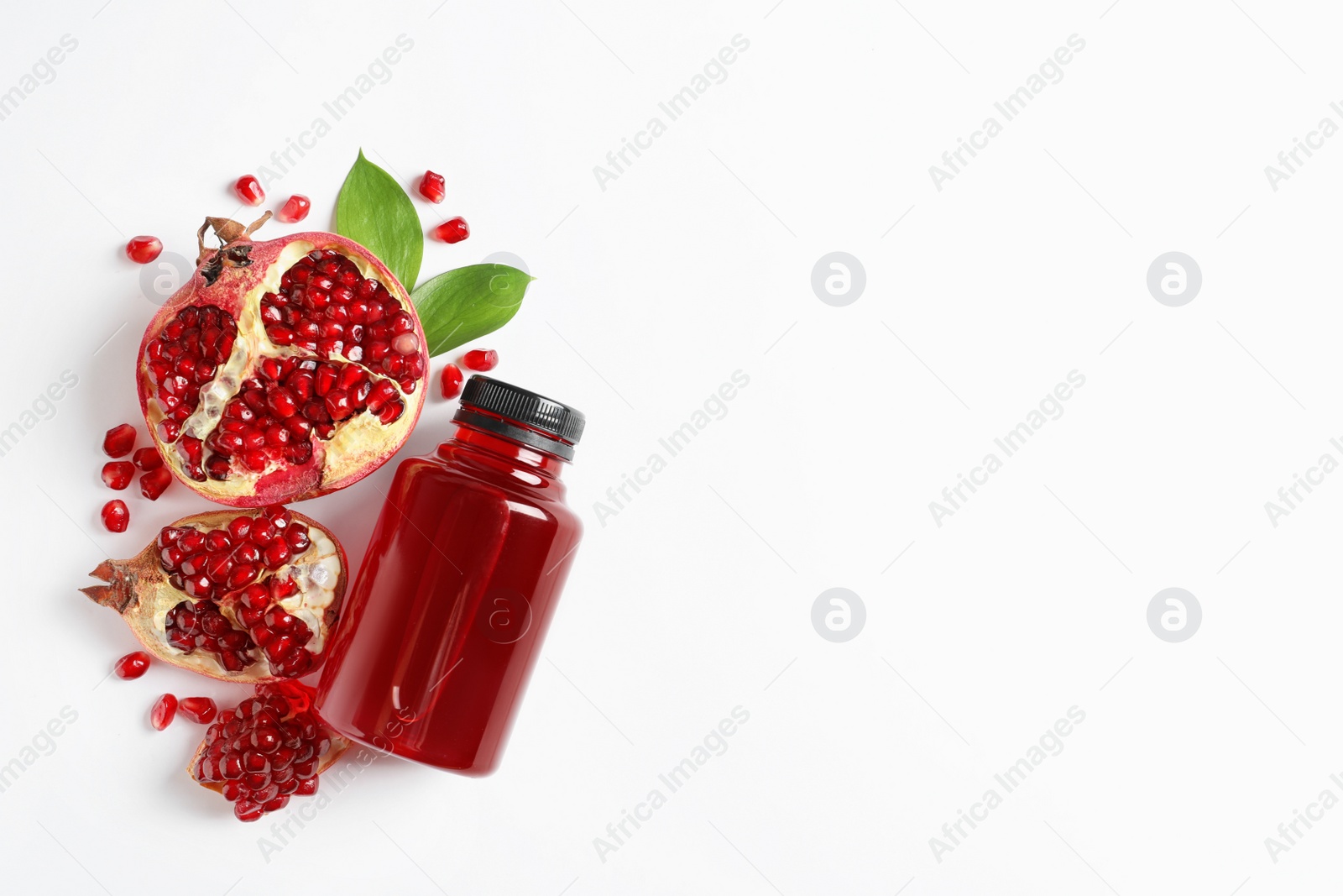 Photo of Bottle of pomegranate juice and fresh fruits on white background, top view