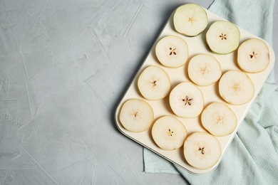 Photo of Flat lay composition with sliced fresh ripe pears and space for text on gray background