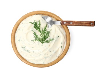 Photo of Tasty creamy dill sauce in bowl with spoon isolated on white, top view