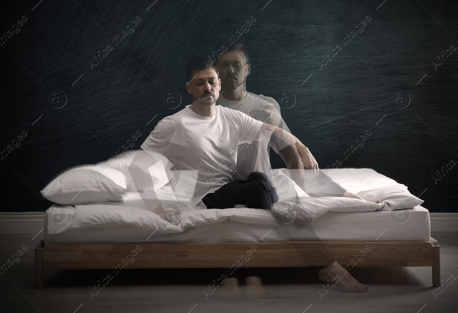 Image of Somnambulist rising from bed near dark wall indoors, multiple exposure. Sleepwalking