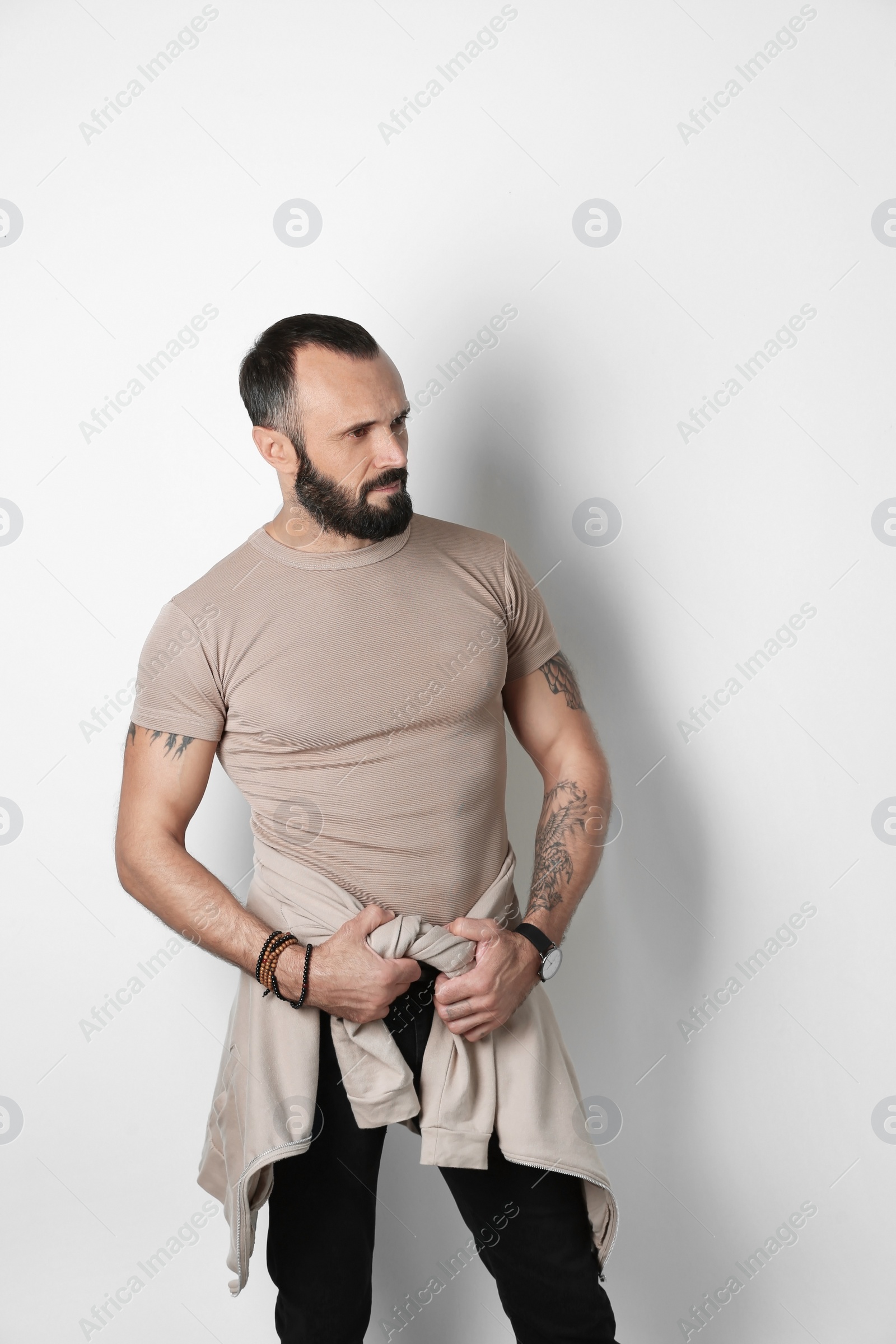 Photo of Portrait of handsome tattooed man on white background