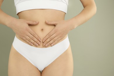 Photo of Gynecology. Woman in underwear on grey background, closeup