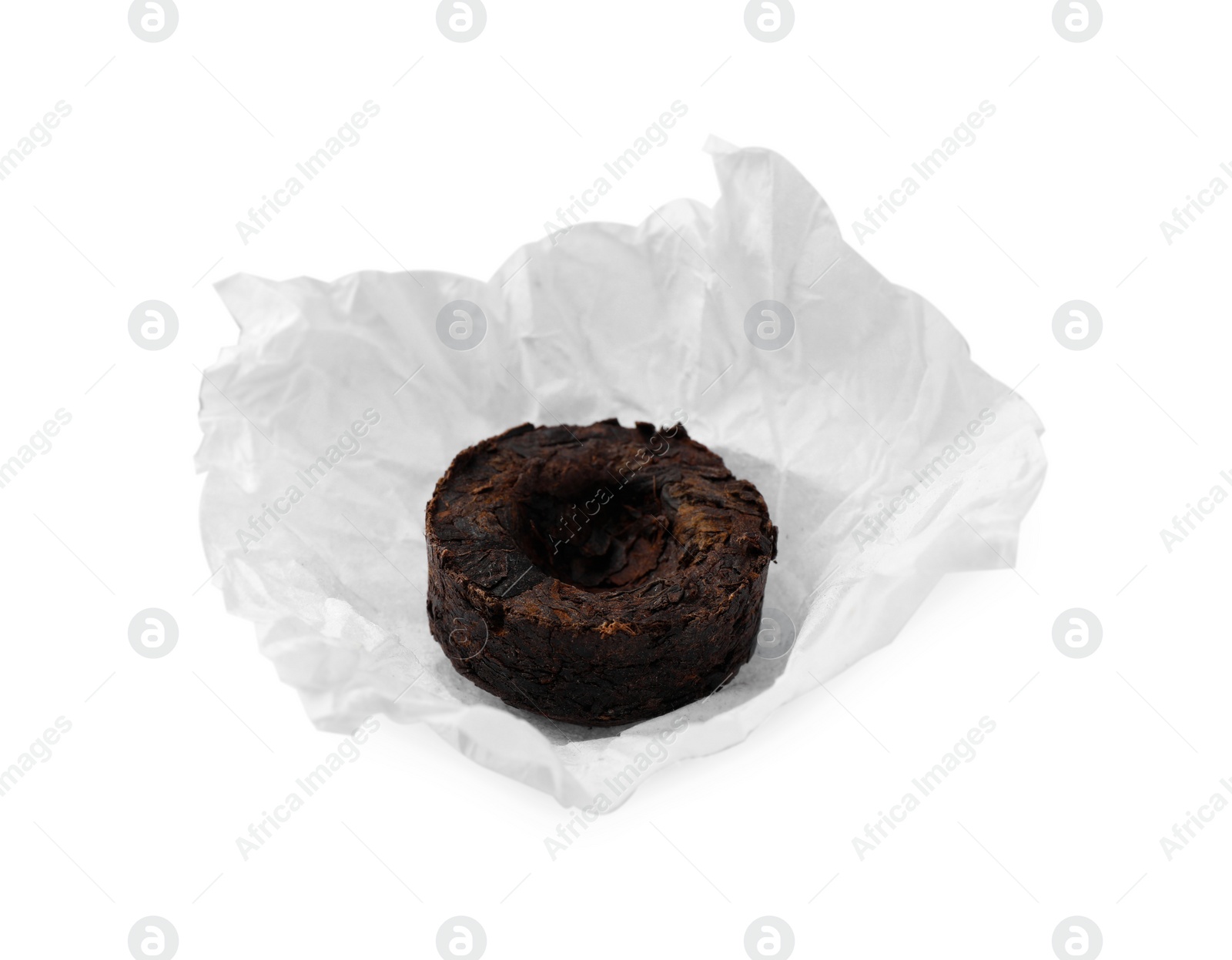 Photo of Cake shaped traditional Chinese pu-erh tea with paper wrap isolated on white