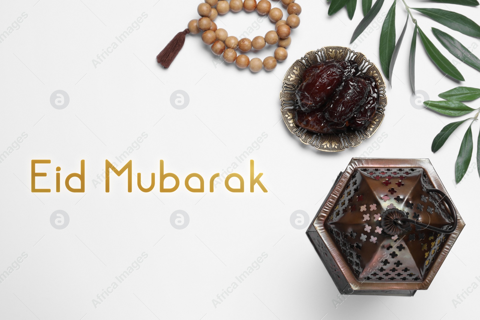 Image of Eid Mubarak greeting card. Flat lay composition with Arabic lantern and misbaha on white table