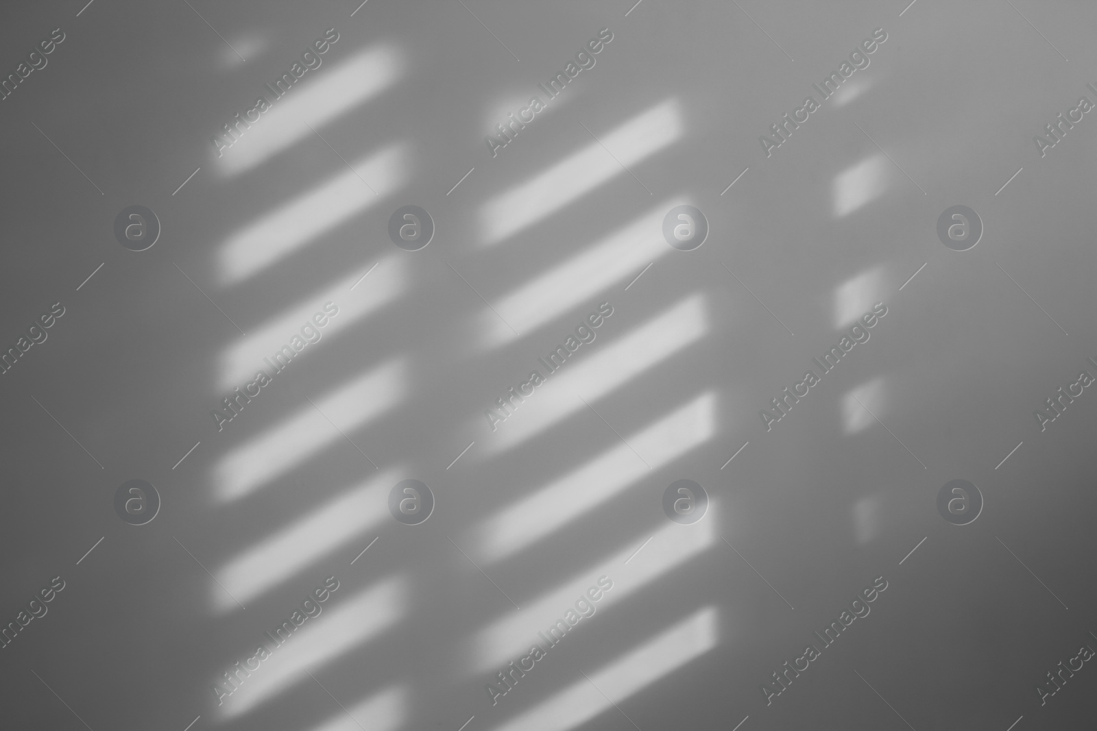 Photo of Light and shadow from window on beige wall indoors