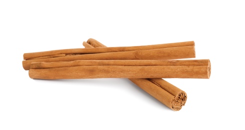 Aromatic dry cinnamon sticks on white background