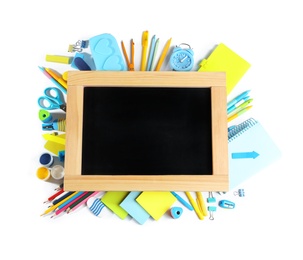 Composition with different school stationery and blank small chalkboard on white background, top view