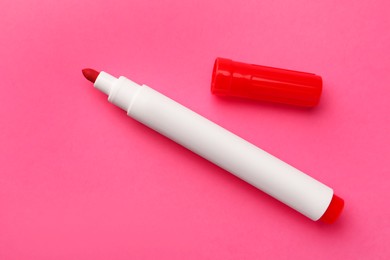 Bright red marker on pink background. Office stationery
