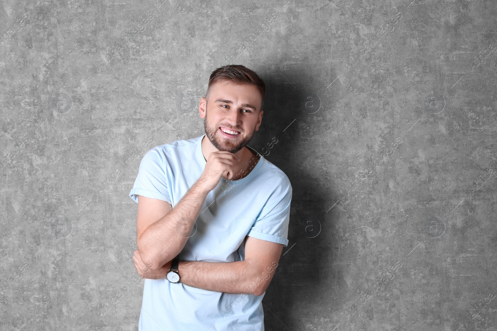 Photo of Portrait of handsome happy man on grey background. Space for text