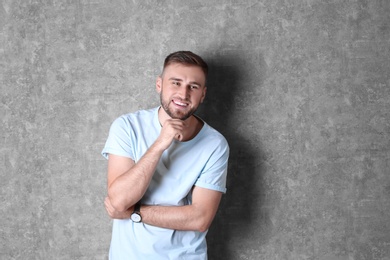 Portrait of handsome happy man on grey background. Space for text