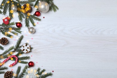 Photo of Flat lay composition with fir branches and Christmas decor on white wooden background, space for text. Greeting card design