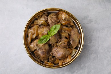 Photo of Delicious fried chicken liver with onion in bowl on light grey table, top view