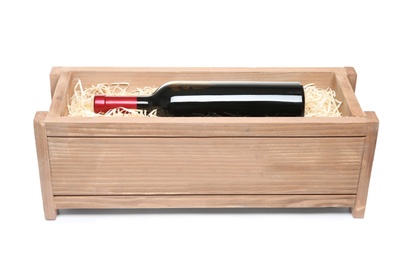 Photo of Open wooden crate with bottle of wine isolated on white