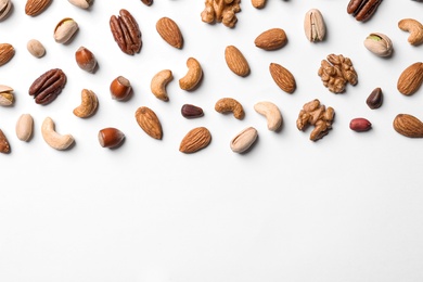 Photo of Composition with organic mixed nuts on white background, top view. Space for text