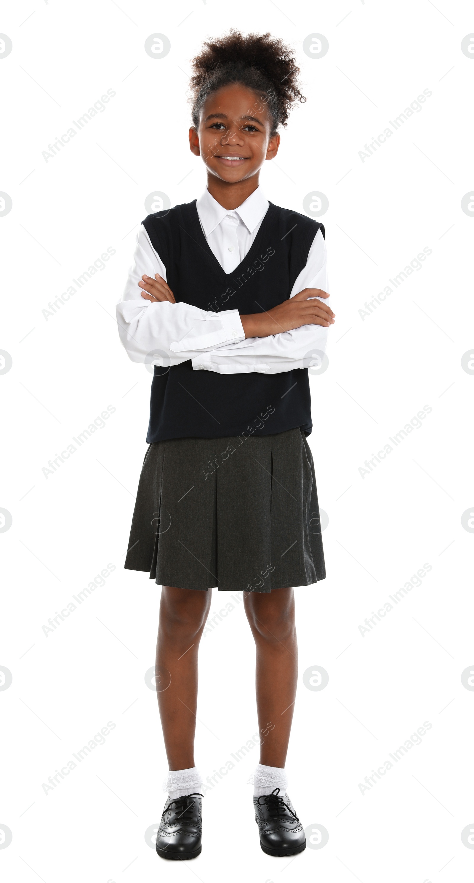 Photo of Happy African-American girl in school uniform on white background