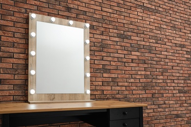 Makeup room interior with wooden table and large mirror