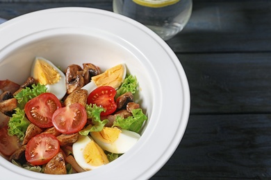 Photo of Plate with delicious fresh salad on table