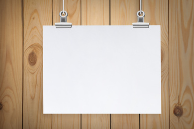 Image of Blank poster hanging near wooden wall. Space for design