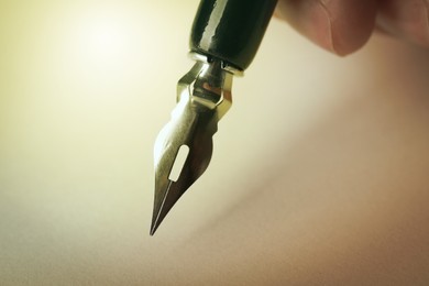 Image of Woman writing with fountain pen, closeup view