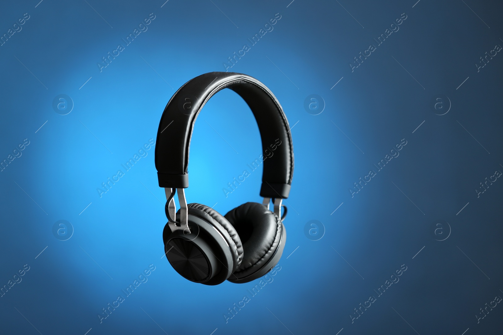 Photo of Stylish headphones on color background. Space for text