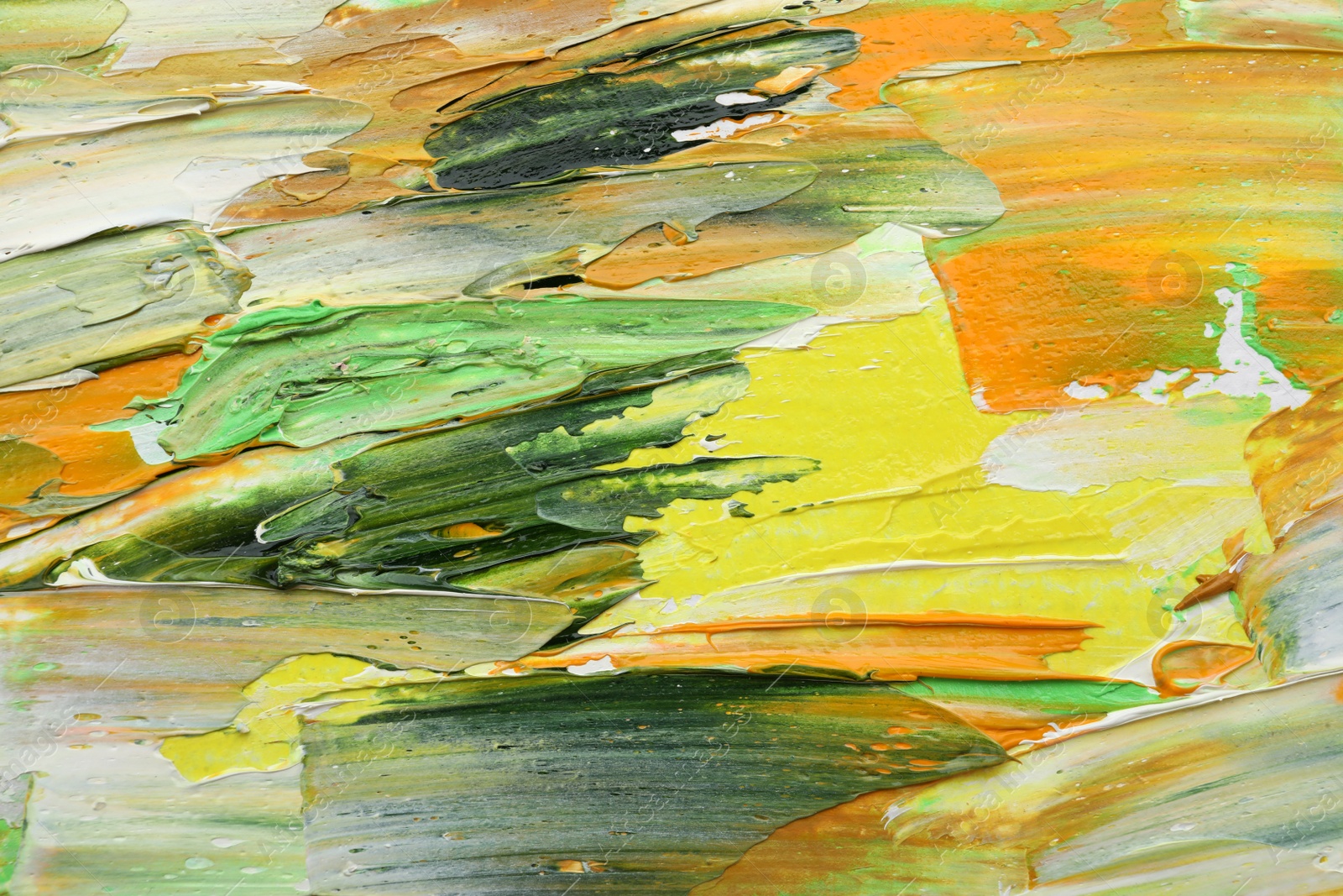 Photo of Beautiful strokes of colorful oil paints as background, closeup