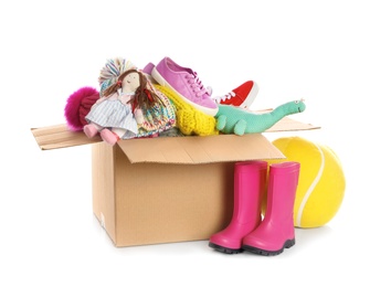 Photo of Donation box, shoes, clothes and toys on white background. Space for text