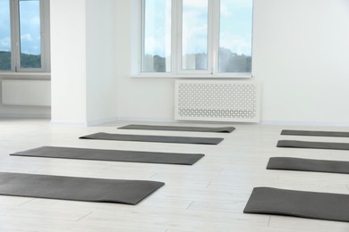 Photo of Spacious yoga studio with exercise mats on floor