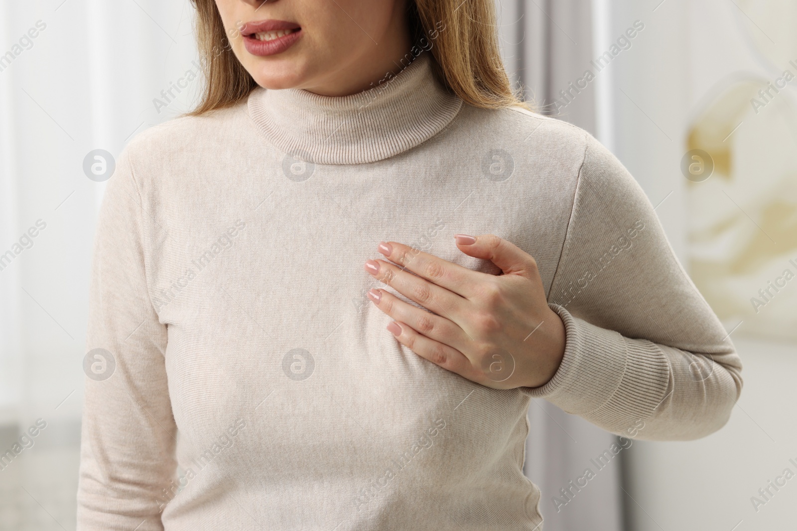 Photo of Mammology. Young woman doing breast self-examination at home, closeup