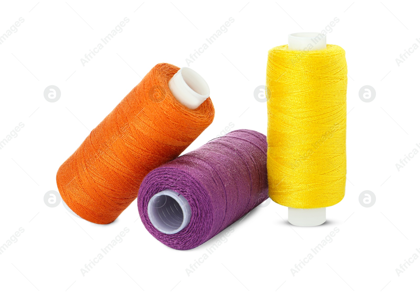 Photo of Different colorful sewing threads on white background