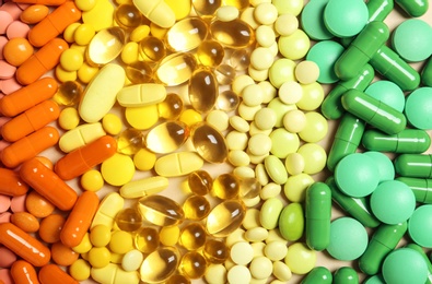 Photo of Different colorful pills as background, top view