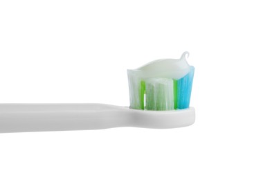 Electric toothbrush with paste on white background, closeup