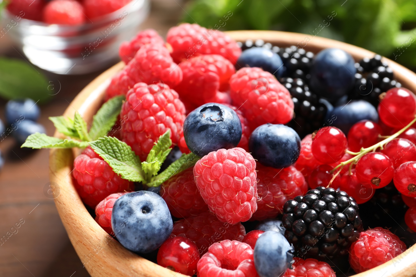 Photo of Bowl with raspberries and different berries, closeup