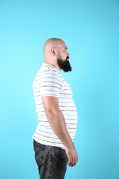 Fat man on color background. Weight loss